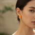Asian model wearing delicate earrings outdoors