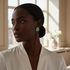 Black model turning gracefully wearing turquoise earrings