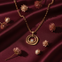 Gold circle necklace on dark red background