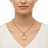 Gold circle necklace on model