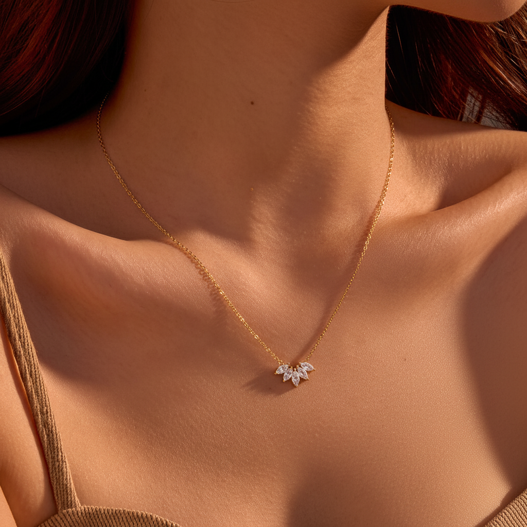 Gold clear zircon crystal leaf necklace on model with white background