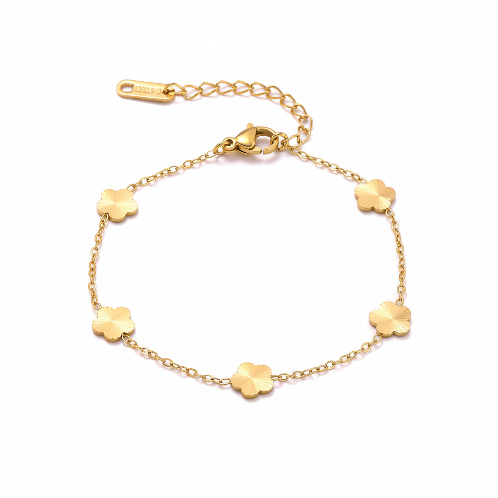 Gold clover charm bracelet on white background