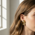 Gold dome and disc earrings indoor model shot - delicate size