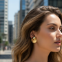 Gold dome and disc earrings outdoor model shot - delicate size
