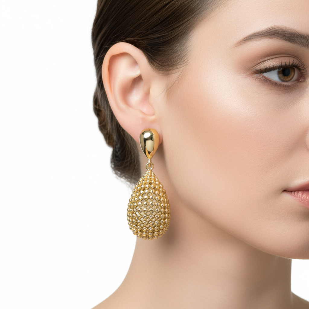 Gold droplet earrings on model