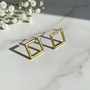 Gold geometric square studs on marble