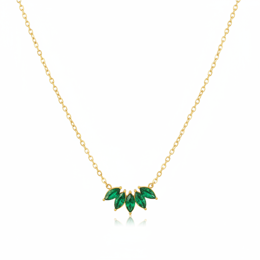 Gold green crystal leaf necklace on white background