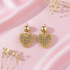 Gold heart earrings flat lay