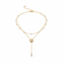 Gold layered pearl necklace on white background