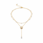 Gold layered pearl necklace on white background