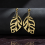 Gold leaf drop earrings dark showcase 1