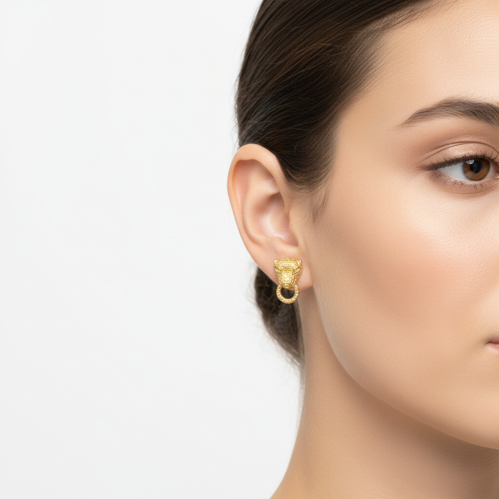 Gold leopard earring closeup on model