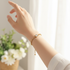 Gold round crystal bracelet on model with bright background