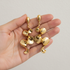Gold sculptural earrings in hand
