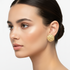 Gold textured circle studs on model