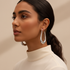 Model wearing Silver Elongated Teardrop Hoop Earrings - Elegant Shot