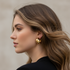 Modern gold hoop earrings on model with loose hair