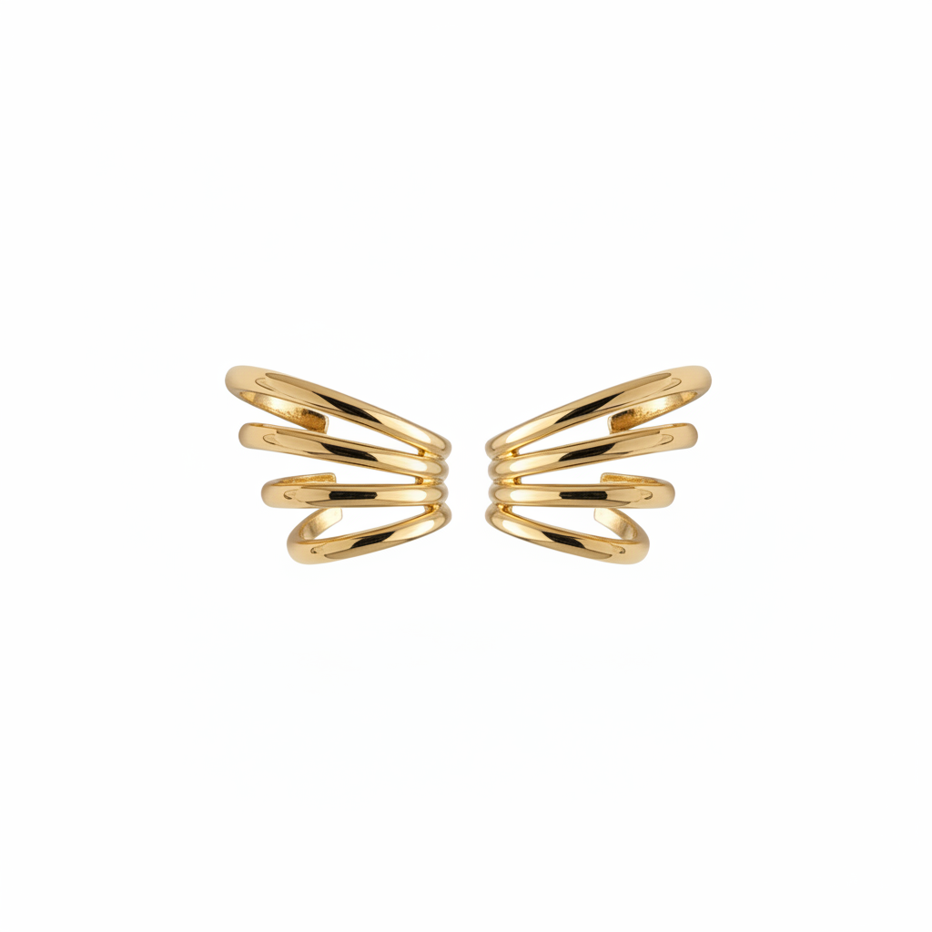 Pair of gold ear cuffs on white background