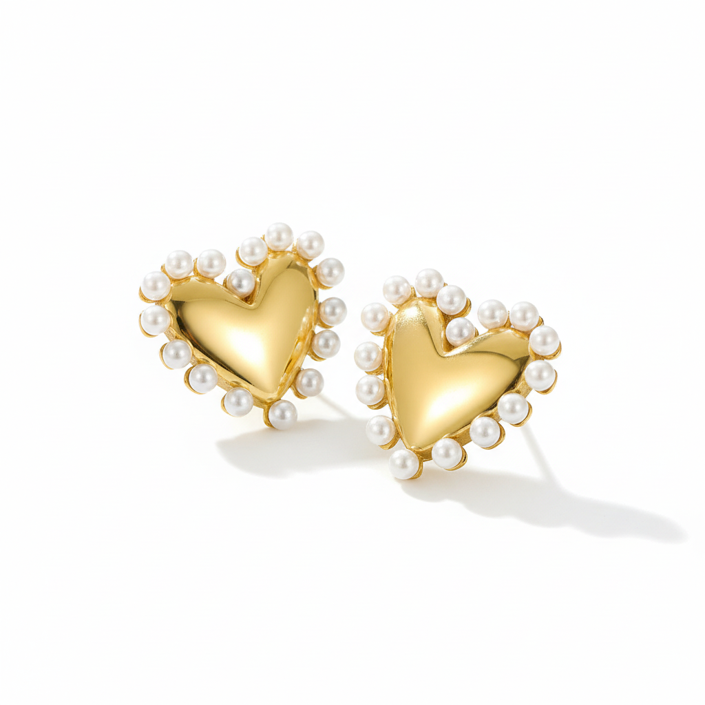 Pearl heart earrings on white background