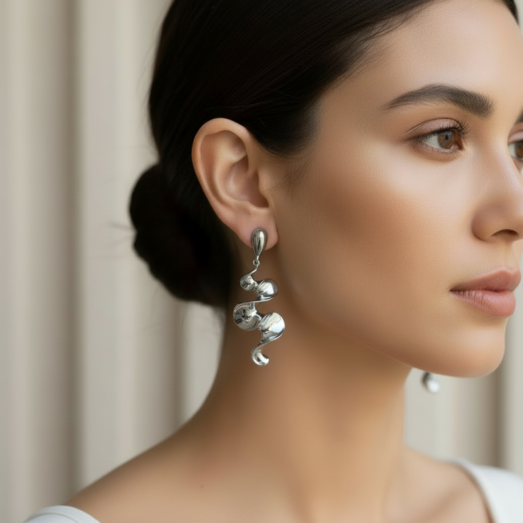Silver sculptural earrings smaller scale on model