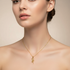 Square format model wearing gold rose necklace