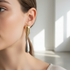 Two-tone drop earrings indoor model shot - correct size