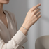 Upper body shot focused on bracelet