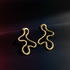 Wavy gold earrings dark showcase 1