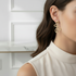 Wavy gold earrings on model - smaller size